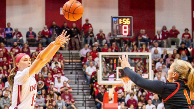 Indiana's Sara Scalia (14) makes a three-pointer over Maryland's Allie Kubek (14) during the first half of the Indiana versus Maryland women's basketball game at Simon Skjodt Assembly Hall on Sunday, March 3, 2024.